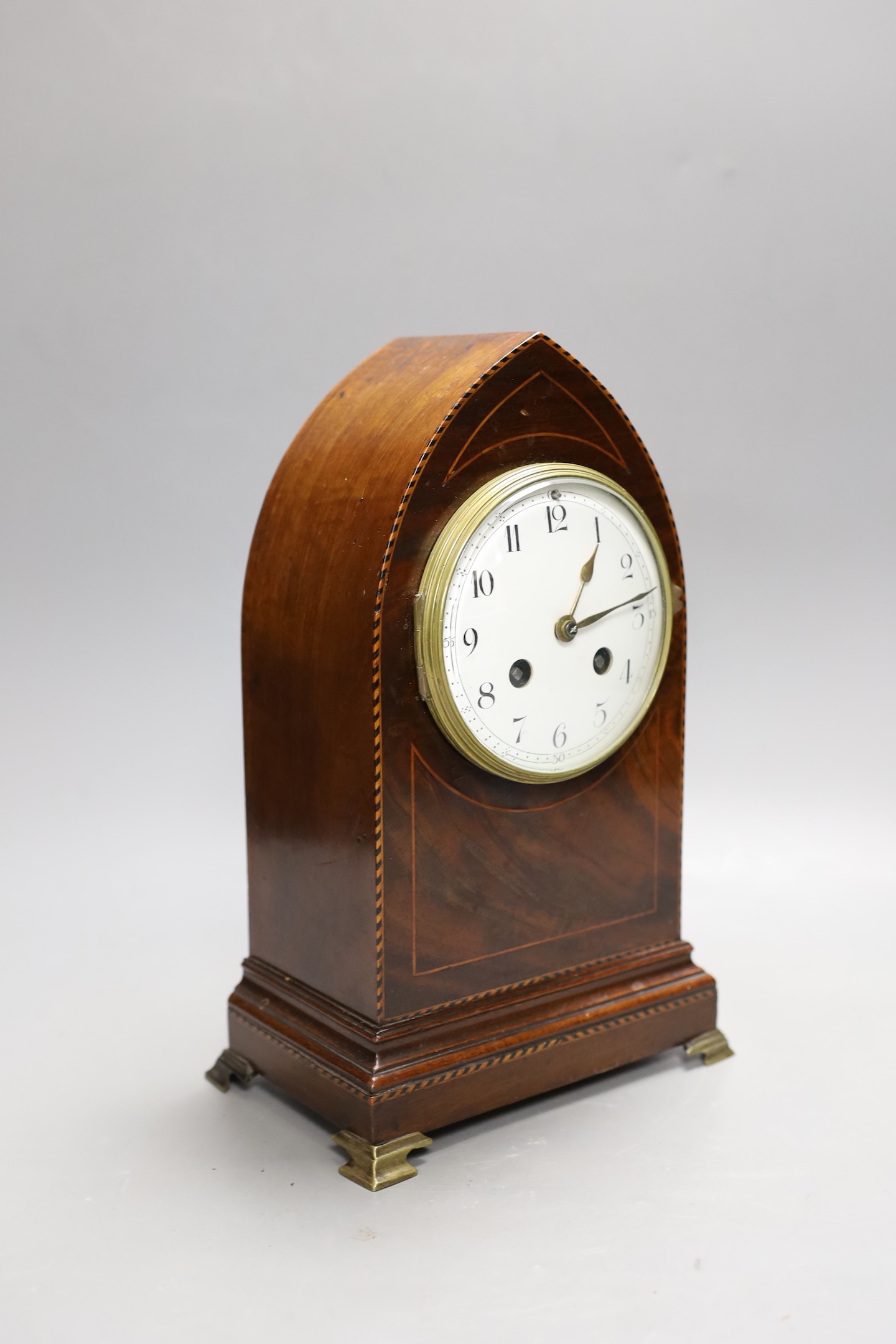An Edwardian strung mahogany veneered lancet mantel clock, 28.5cm high